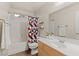 Well-lit bathroom with a tub, shower, sink, large mirror, and modern fixtures at 1079 Oak Shade Ln, Henderson, NV 89015