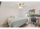 Cozy bedroom with ceiling fan, natural light, and dedicated workspace at 1079 Oak Shade Ln, Henderson, NV 89015