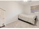 Neutral bedroom featuring a striped bedspread, window, and decorative armoire at 1079 Oak Shade Ln, Henderson, NV 89015