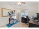 Bright room showcasing an exercise machine, home office setup, and plush carpet at 1079 Oak Shade Ln, Henderson, NV 89015