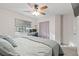 Bright bedroom featuring a ceiling fan, window with blinds, and a comfortable-looking bed at 1079 Oak Shade Ln, Henderson, NV 89015