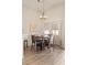Bright dining area with modern light fixture, hardwood floors, and large windows at 1079 Oak Shade Ln, Henderson, NV 89015