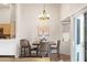 Bright dining area with modern light fixture, hardwood floors, and sliding glass door at 1079 Oak Shade Ln, Henderson, NV 89015
