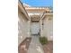Welcoming entryway featuring a decorative 'HOME' sign, and easy-care landscaping at 1079 Oak Shade Ln, Henderson, NV 89015