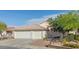 Charming home featuring a well-manicured lawn, mature tree, and a convenient three-car garage at 1079 Oak Shade Ln, Henderson, NV 89015