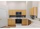 Well-lit kitchen with stainless steel appliances, ample cabinetry, and easy access to the dining area at 1079 Oak Shade Ln, Henderson, NV 89015