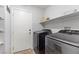 Clean laundry room featuring front-loading washer and dryer and built-in shelving at 1079 Oak Shade Ln, Henderson, NV 89015