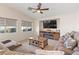 Comfortable living room with a fireplace, large sectional, and stylish decor, perfect for relaxation at 1079 Oak Shade Ln, Henderson, NV 89015
