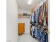 Spacious walk-in closet provides ample storage space, shelving, and a built-in cabinet at 1079 Oak Shade Ln, Henderson, NV 89015