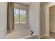 Bathroom showcasing a soaking tub with a window view and a glass enclosed shower at 108 Broken Rock Dr, Henderson, NV 89074