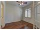 Inviting bedroom featuring hardwood floors, a ceiling fan, shutters and two entry doors at 108 Broken Rock Dr, Henderson, NV 89074