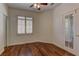 Bright bedroom with hardwood floors, large window with shutters, and glass panel door at 108 Broken Rock Dr, Henderson, NV 89074