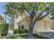 Charming townhouse showcasing a well-kept lawn and inviting two-car garage, with mature trees providing ample shade at 108 Broken Rock Dr, Henderson, NV 89074