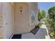 Close-up of the stucco house exterior, showcasing an elegant entrance with stylish lighting fixture and manicured garden at 108 Broken Rock Dr, Henderson, NV 89074