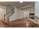 Spacious living area with hardwood floors, a staircase, and a fireplace, blending comfort and style for relaxation and enjoyment at 108 Broken Rock Dr, Henderson, NV 89074