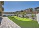 Beautiful backyard with a putting green, desert landscaping, and privacy fencing creating a serene outdoor retreat at 12438 Heritage Bend Dr, Las Vegas, NV 89138