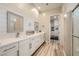 Modern bathroom with double vanity, wood-look tile, and updated fixtures at 12438 Heritage Bend Dr, Las Vegas, NV 89138