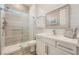 Modern bathroom with a glass-enclosed shower, white vanity, and shiplap walls, offering a clean and serene space at 12438 Heritage Bend Dr, Las Vegas, NV 89138