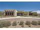 Modern home with clean lines, desert landscaping, and a brick driveway offers stylish curb appeal at 12438 Heritage Bend Dr, Las Vegas, NV 89138