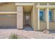 Close-up showcasing front door with stone accents, a brick walkway, and desert landscaping at 12438 Heritage Bend Dr, Las Vegas, NV 89138