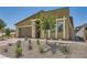 Inviting front exterior featuring desert landscaping and a well-maintained facade under a clear sky at 12438 Heritage Bend Dr, Las Vegas, NV 89138