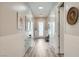 Bright hallway with wood floors, white wainscoting, and a skylight for natural light at 12438 Heritage Bend Dr, Las Vegas, NV 89138