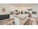 Bright kitchen features a large center island, stainless steel appliances, and sleek white cabinetry at 12438 Heritage Bend Dr, Las Vegas, NV 89138