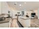 Open kitchen with a central island, stainless appliances, and a view into the living area at 12438 Heritage Bend Dr, Las Vegas, NV 89138