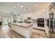 Open kitchen with a large island, modern cabinets, and stainless steel appliances at 12438 Heritage Bend Dr, Las Vegas, NV 89138