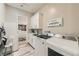 Bright laundry room with white cabinets, a sink, modern washer/dryer, and an adjacent walk-in closet at 12438 Heritage Bend Dr, Las Vegas, NV 89138