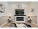 Cozy living room featuring a modern fireplace, large TV, and stylish decor at 12438 Heritage Bend Dr, Las Vegas, NV 89138
