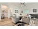 Airy living area with wood floors, white sectional sofa, and ample natural light at 12438 Heritage Bend Dr, Las Vegas, NV 89138