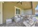 Covered outdoor patio featuring comfortable seating, a built-in grill, and a patterned tile floor for stylish entertaining at 12438 Heritage Bend Dr, Las Vegas, NV 89138