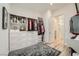 Spacious walk-in closet features built-in shelving, drawers, and a gray rug on wood-style flooring at 12438 Heritage Bend Dr, Las Vegas, NV 89138