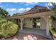 Covered patio with outdoor furniture in a backyard with landscaping and mature trees at 1305 Chaparral Summit Dr, Las Vegas, NV 89117