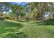 Expansive green backyard with mature trees and landscaping at 1305 Chaparral Summit Dr, Las Vegas, NV 89117