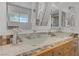 Modern bathroom featuring dual glass vessel sinks and decorative tile accents at 1305 Chaparral Summit Dr, Las Vegas, NV 89117