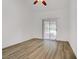 Bedroom with hardwood floors and sliding glass doors to the outside at 1305 Chaparral Summit Dr, Las Vegas, NV 89117