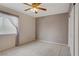 Cozy bedroom with neutral walls, ceiling fan, and large window providing natural light at 1305 Chaparral Summit Dr, Las Vegas, NV 89117