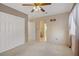 Bedroom with a ceiling fan, closet, and doorways leading to a bathroom at 1305 Chaparral Summit Dr, Las Vegas, NV 89117