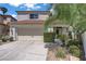 Charming two-story home featuring a well-manicured yard and attached two-car garage at 1305 Chaparral Summit Dr, Las Vegas, NV 89117