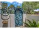 Unique gated entry with artistic metalwork and lush greenery at 1305 Chaparral Summit Dr, Las Vegas, NV 89117