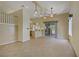 Living room with tile floors, high ceilings, and a sliding glass door to the outside patio at 1305 Chaparral Summit Dr, Las Vegas, NV 89117