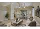 Bright living room features a staircase, breakfast bar, and stylish dining area with backyard access at 1305 Chaparral Summit Dr, Las Vegas, NV 89117