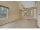 Bright living room features high ceilings, tile flooring, and large windows at 1305 Chaparral Summit Dr, Las Vegas, NV 89117