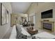 Spacious living room showcasing a fireplace, dining area, and modern, neutral decor at 1305 Chaparral Summit Dr, Las Vegas, NV 89117