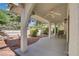 Covered patio with ceiling fan and outdoor seating, overlooking a well-maintained yard at 1305 Chaparral Summit Dr, Las Vegas, NV 89117
