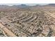 Panoramic aerial view showcasing a Primary-planned community with uniform homes and curved streets against a mountain backdrop at 132 Soaring Sky Ave, Henderson, NV 89011