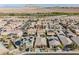 Aerial shot captures a neighborhood with houses featuring solar panels and a community pool, highlighting energy efficiency at 132 Soaring Sky Ave, Henderson, NV 89011