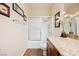 Neutral bathroom featuring a shower-tub, granite countertop, and decorative accents at 132 Soaring Sky Ave, Henderson, NV 89011
